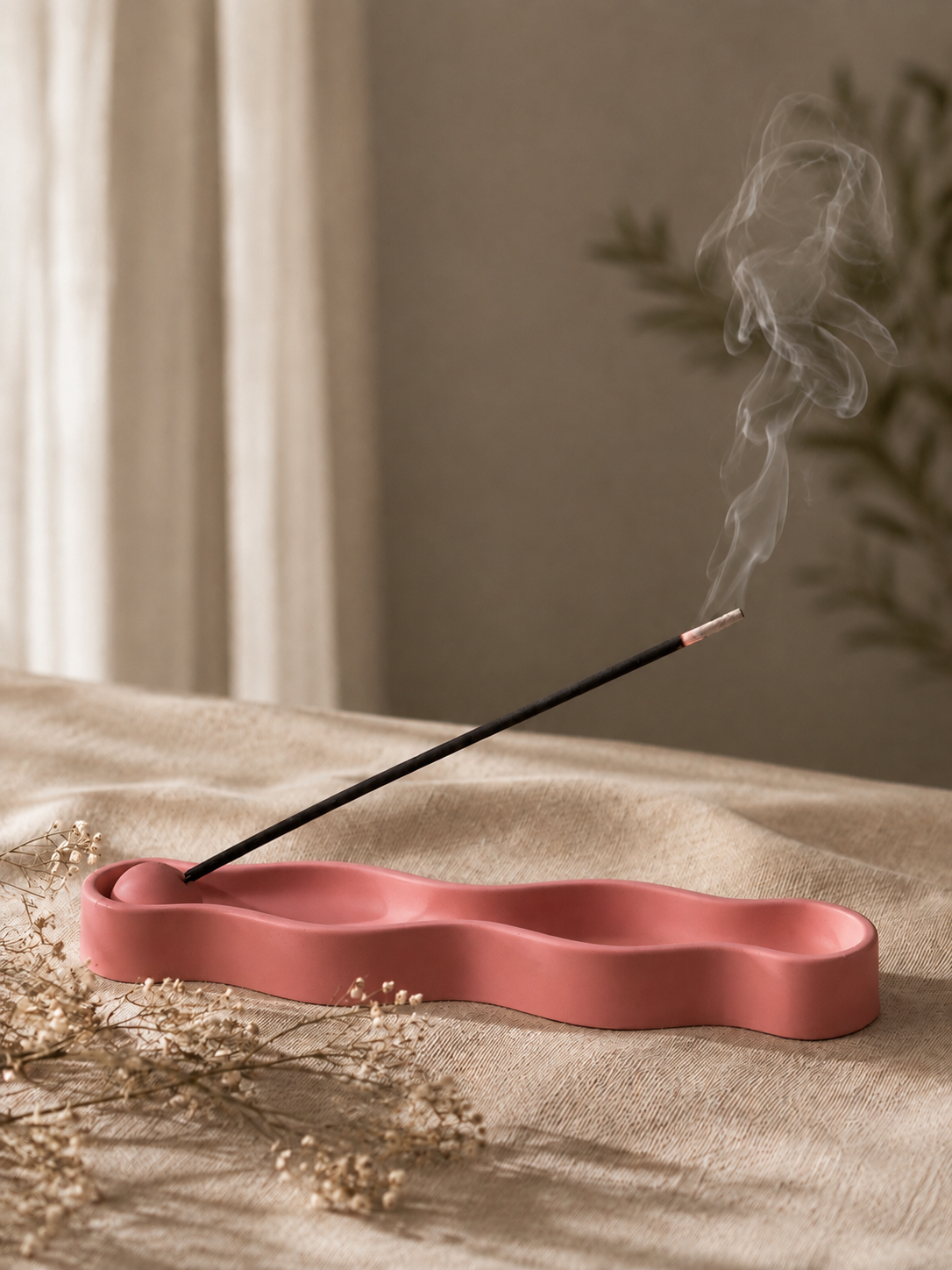 Ripple Incense Holder in red with lit incense stick