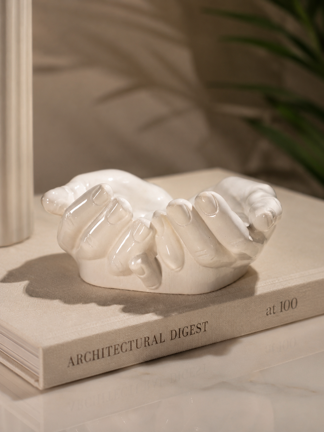 The Giving Hands interlocked sculpture on Architectural Digest book