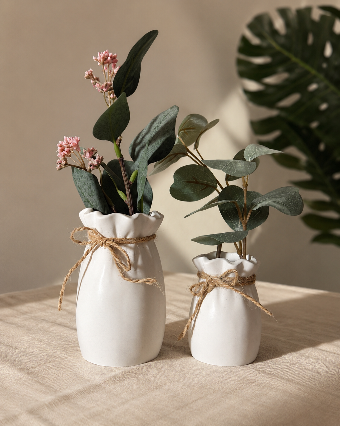 Ruffle Neck Ceramic Vase in matte white with jute bow, styled with eucalyptus and pink flowers