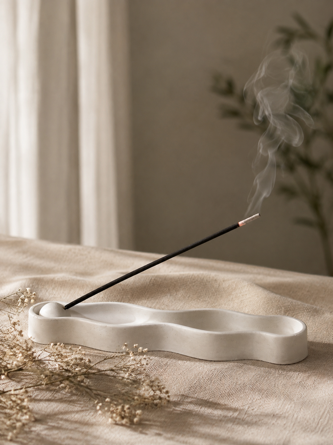Ripple Incense Holder in white with lit incense stick