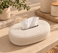 Woven tissue box cover in mixed beige jute on a stone surface