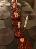 Ember table set – terracotta red crinkle runner with dark woven placemats overhead view