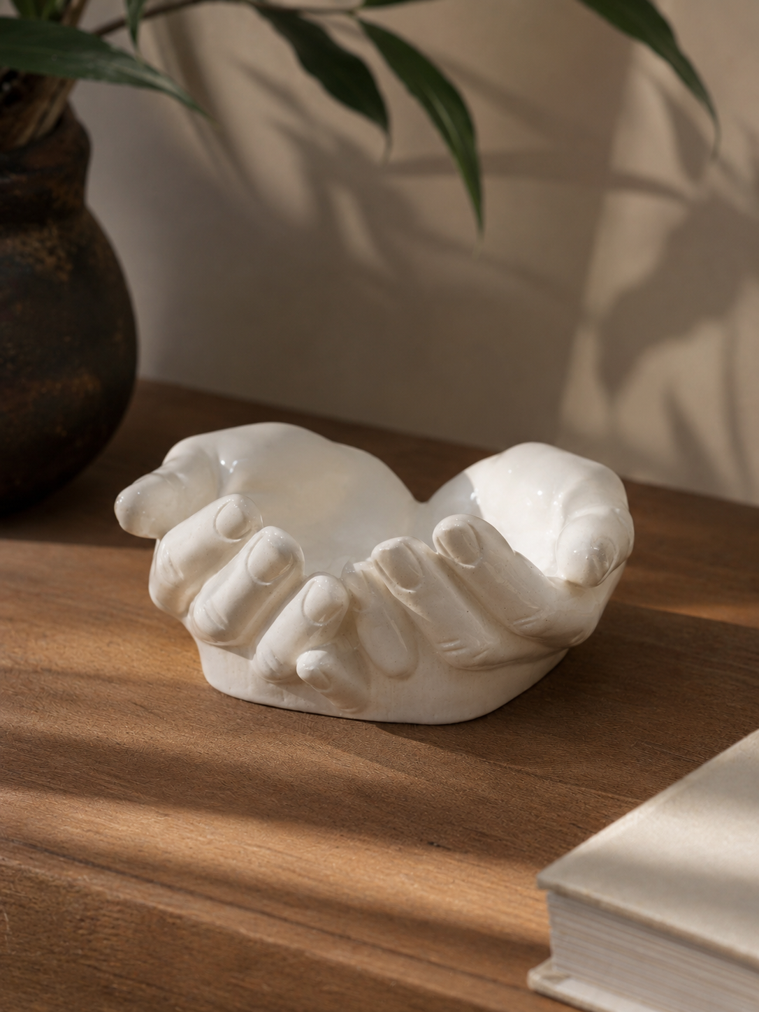 The Giving Hands cupped sculpture on wooden surface